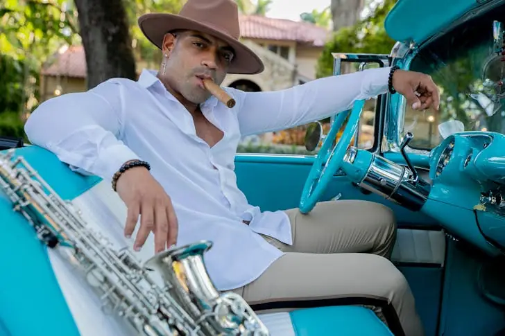Why are Cuban cigars illegal - A man using Cuban cigar in a car.
